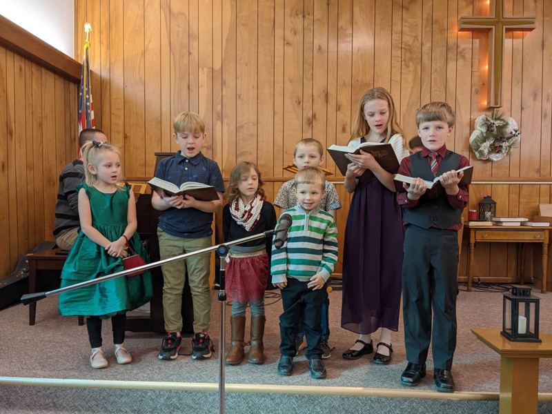 Children singing together at the front of the sanctuary